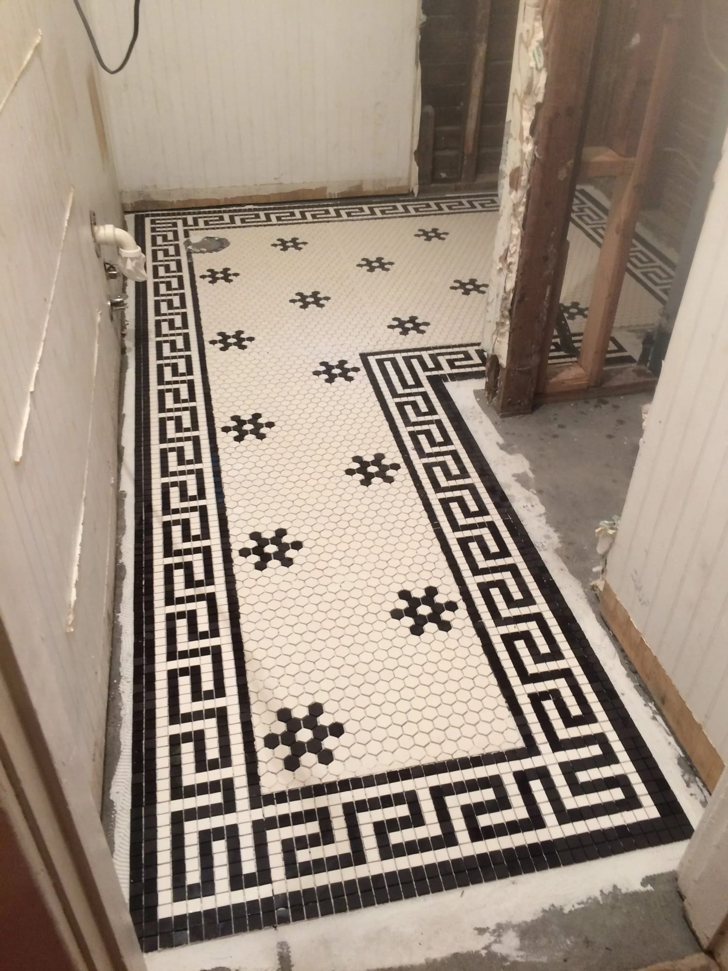 Original mosaic tile floor restored during a whole-home renovation